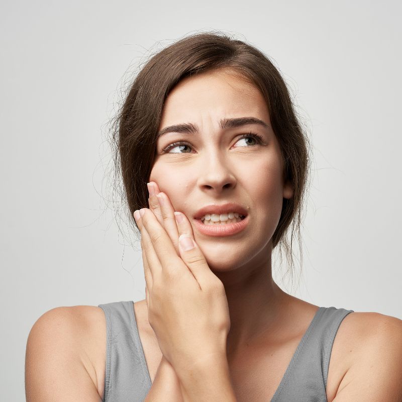 Woman experiencing toothache pain